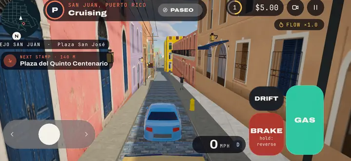 A narrow Old San Juan street of blue cobblestones between pink and blue houses
